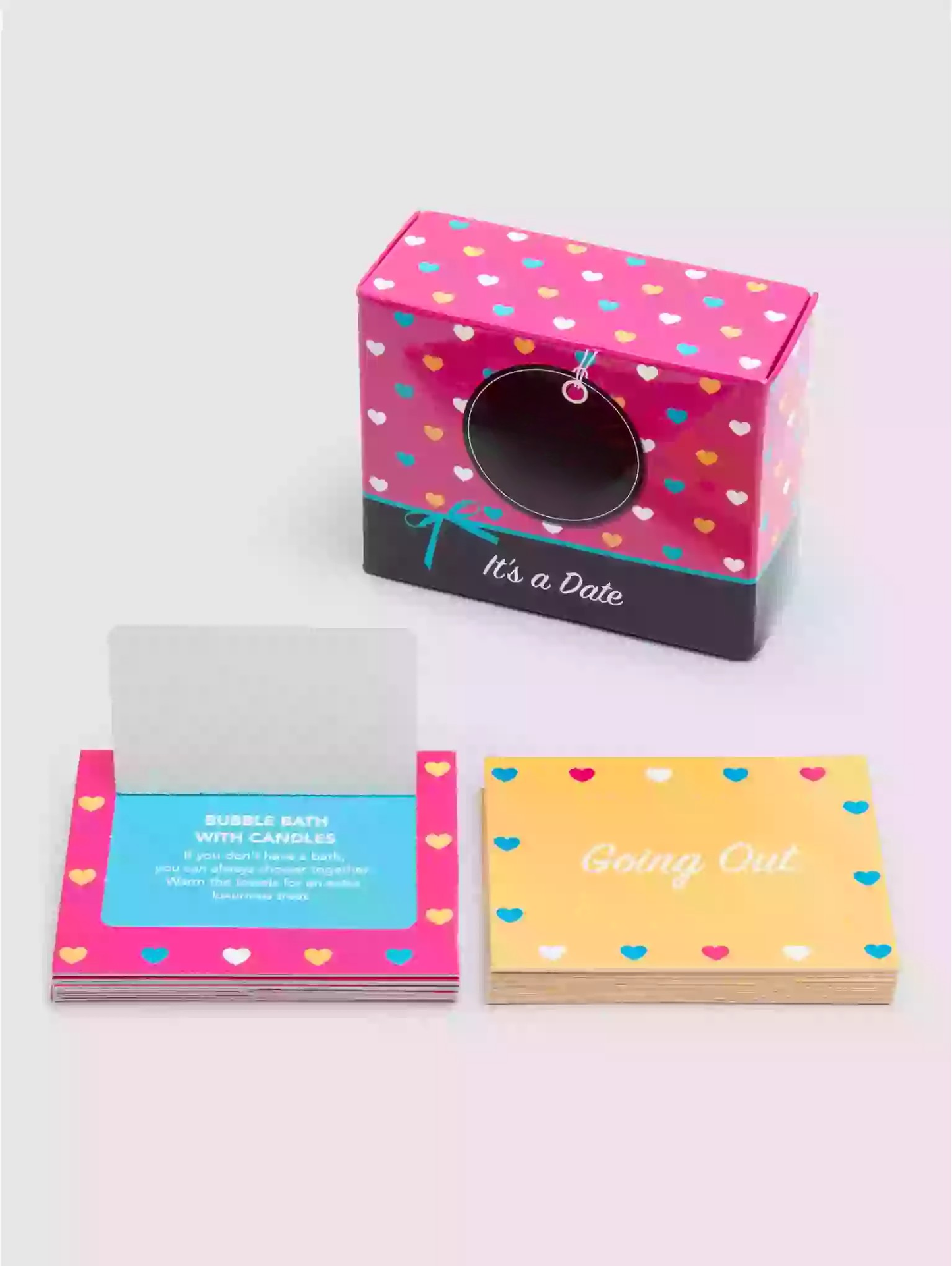 Colorful box with heart pattern and cards on a white background