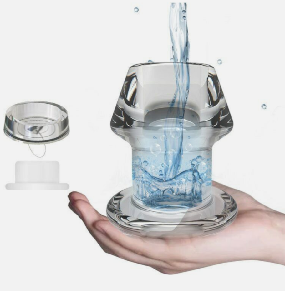 Glass container with water being poured into it held in a hand against a white background