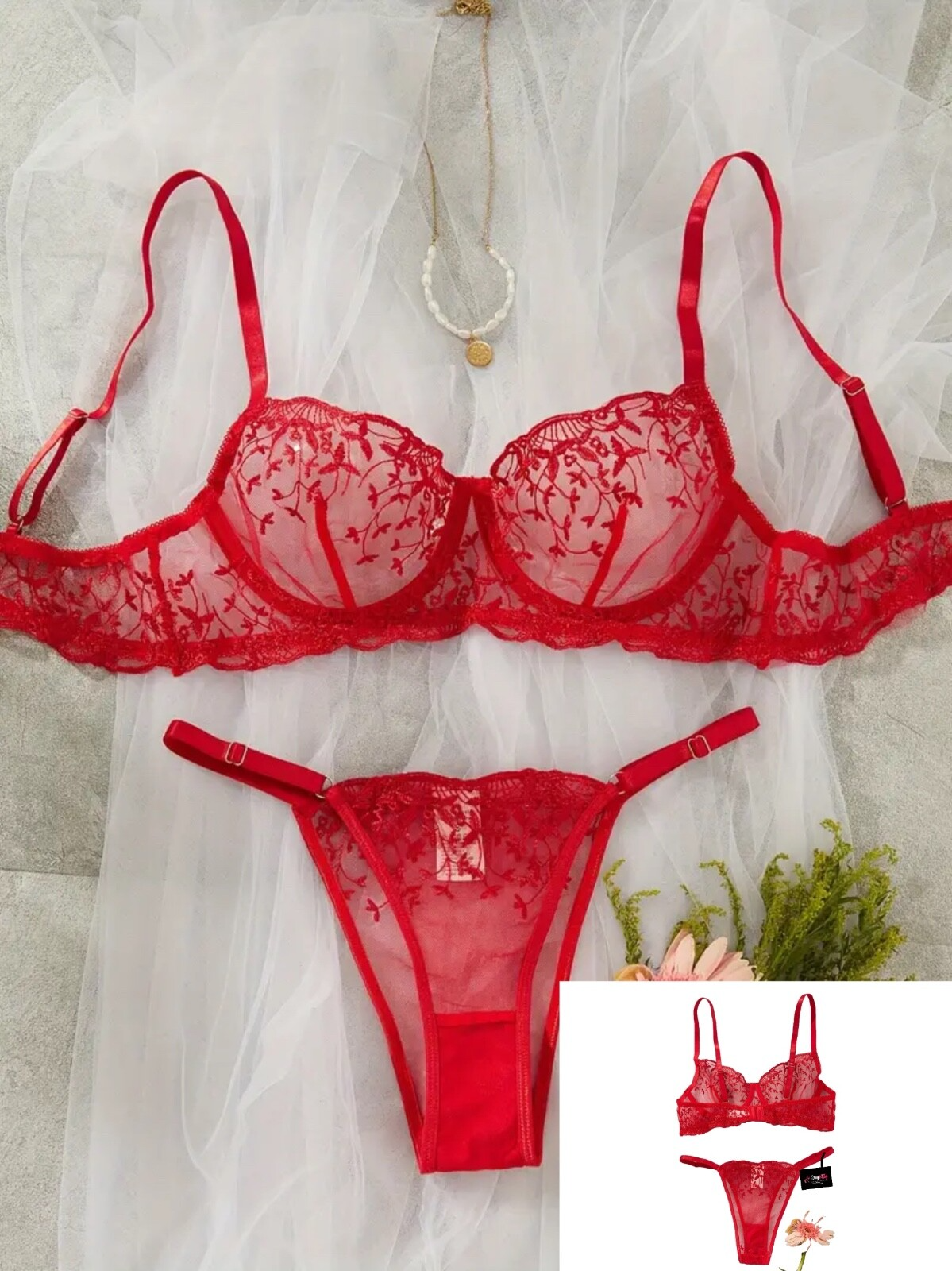 Red lace lingerie set on a white background