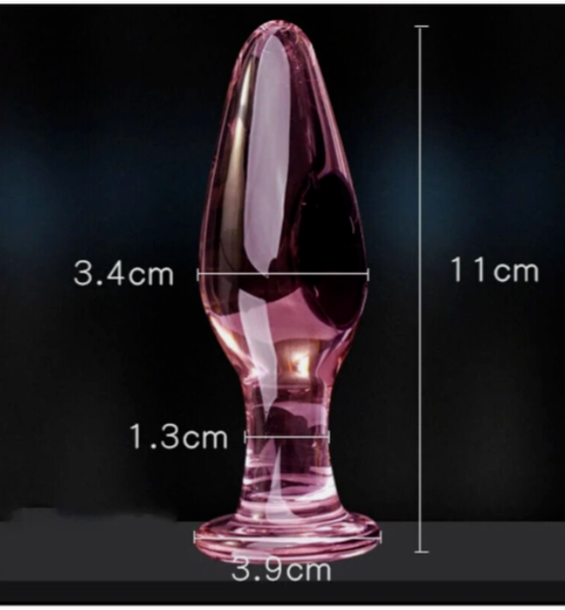 Pink cylindrical object with measurements on a black background