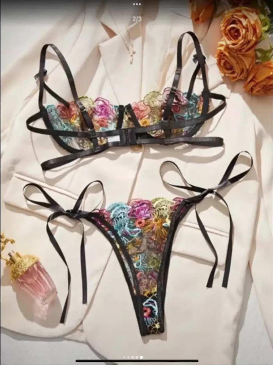 Black bikini set with floral designs on a white background