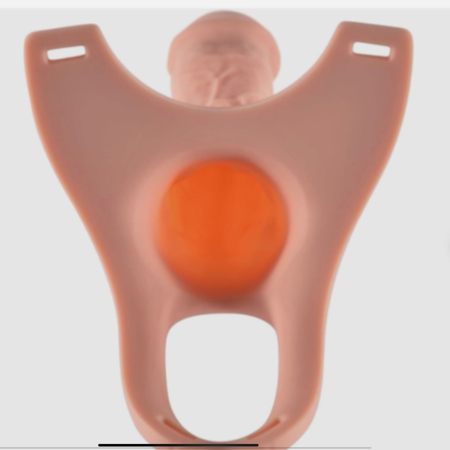 Silicone mold shaped like a person with an orange center on a white background