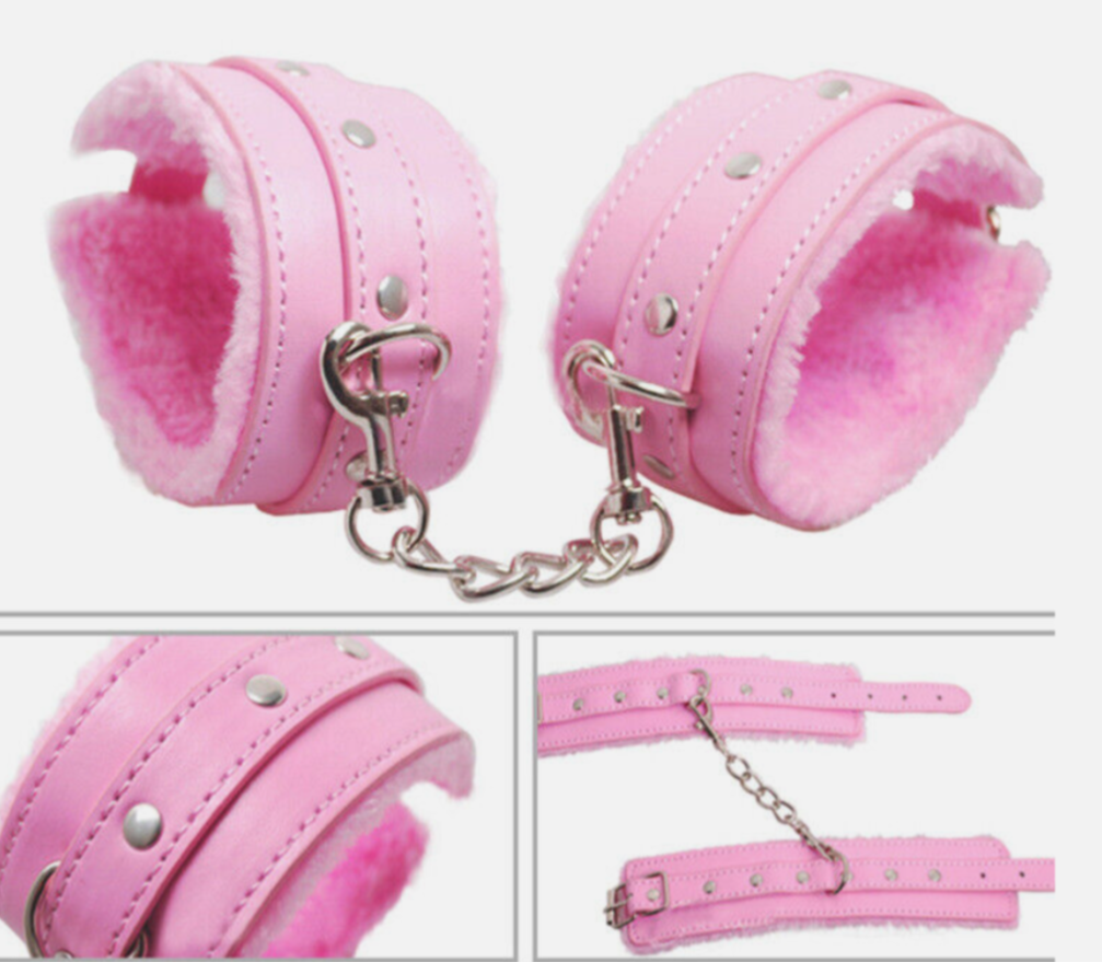 Pink leather cuffs with chain on a white background