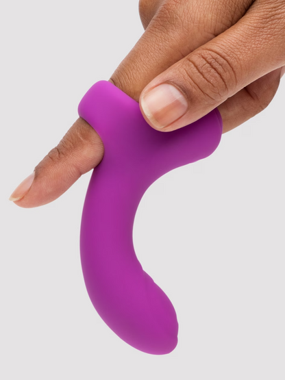 Purple silicone ring held by a hand on a light gray background
