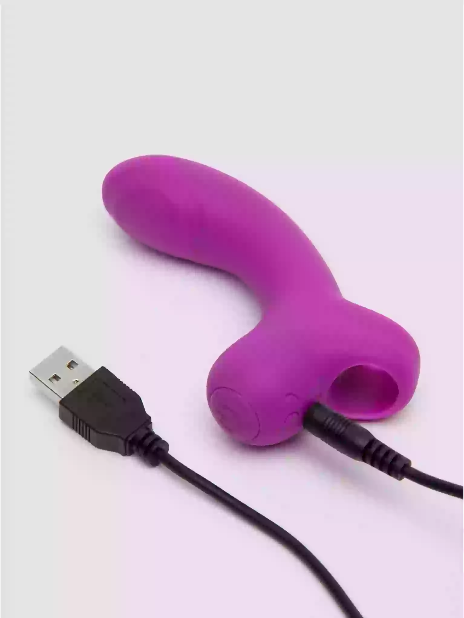Purple silicone device with USB cable on a white background