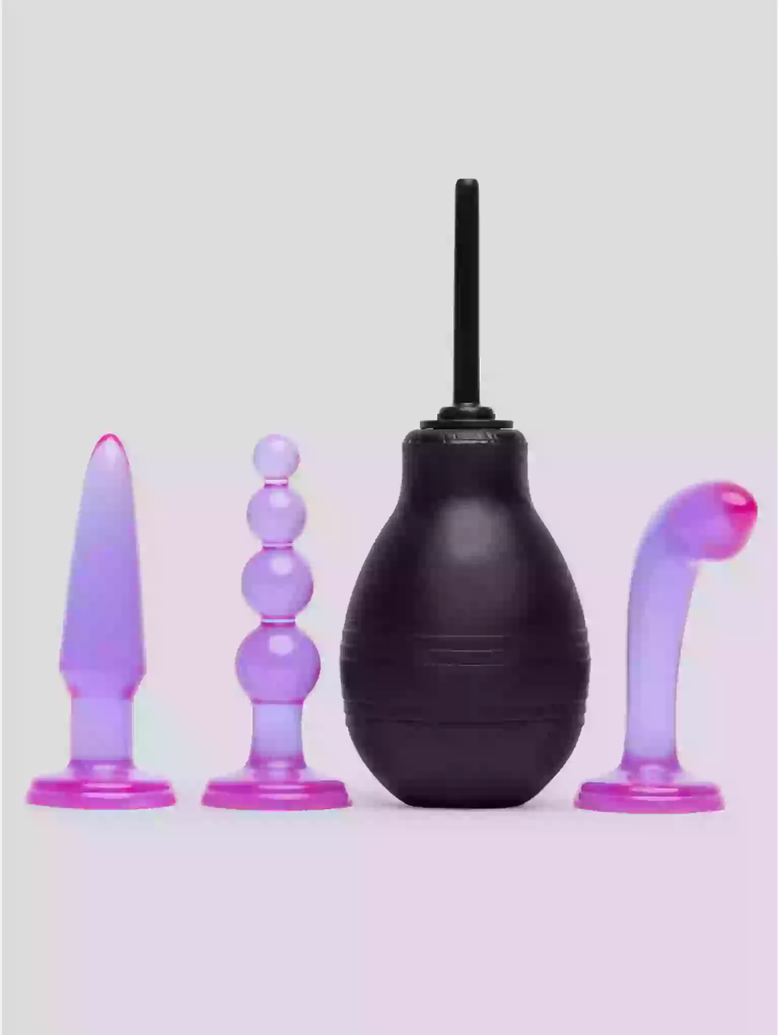 Set of four purple and black silicone butt plugs on a light gray background
