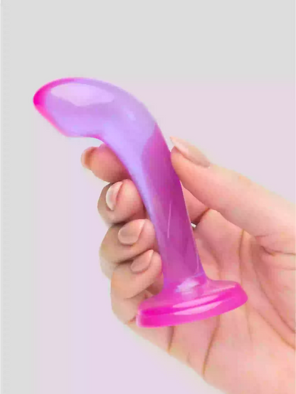 Hand holding a purple and pink silicone object against a light gray background