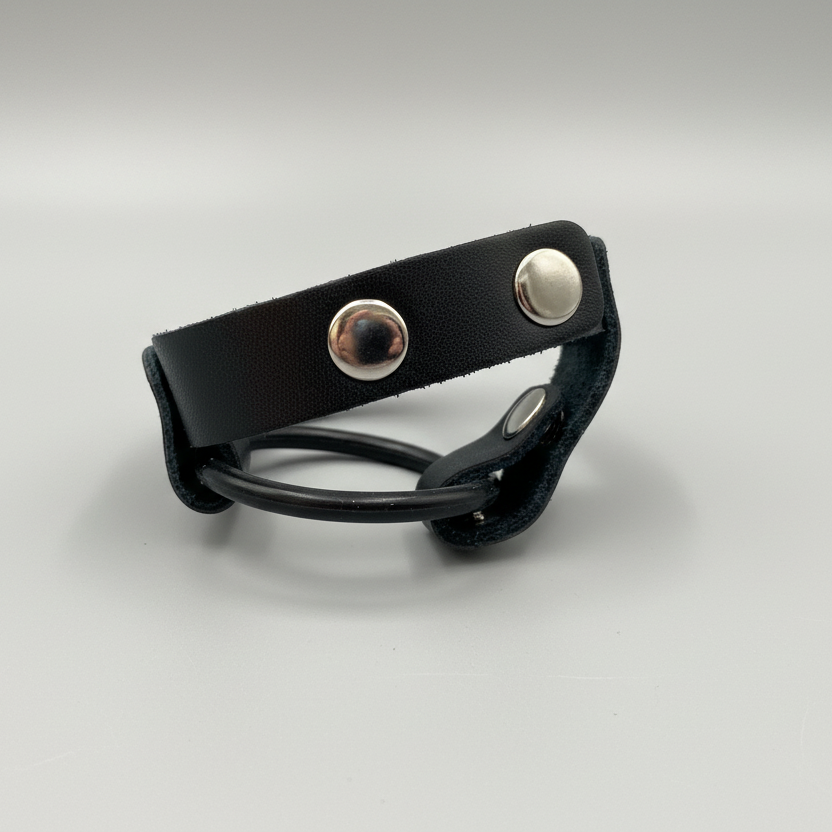 Black leather bracelet with silver buttons on a light gray background