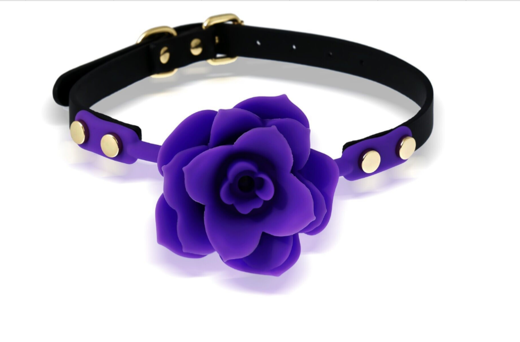 Black leather collar with a large purple flower on a white background