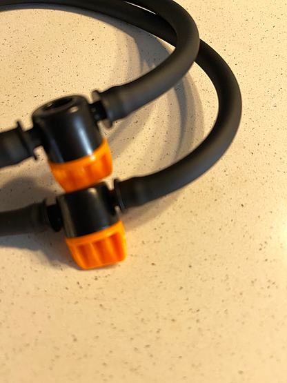 Black and orange cable on a beige surface
