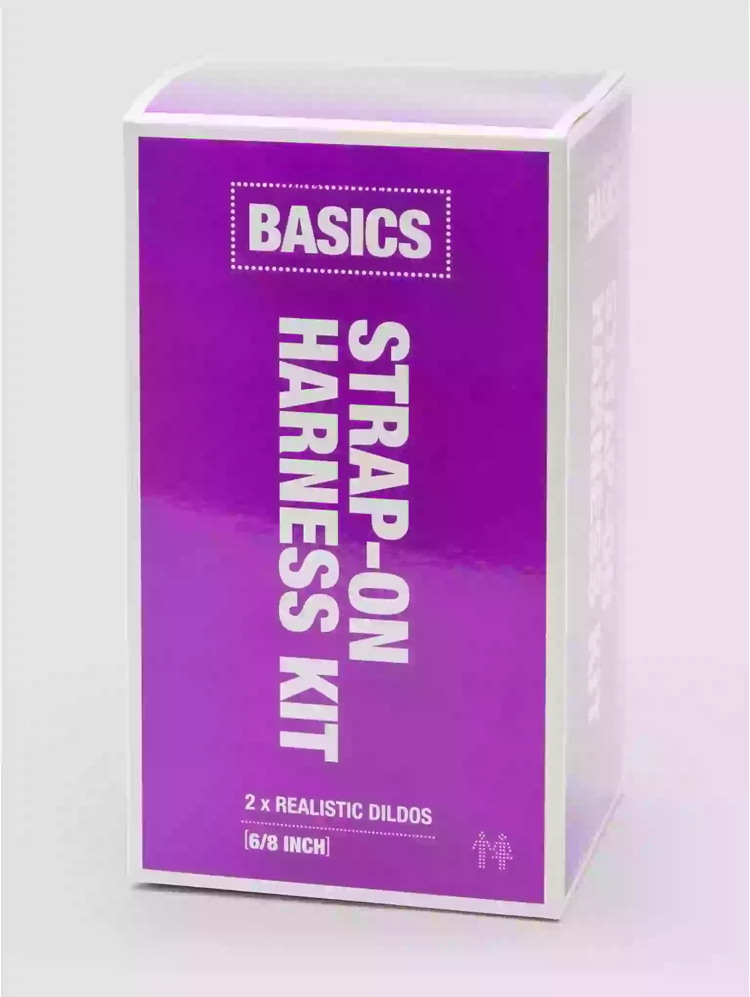 Purple packaging of a 'Basics' strap-on harness kit on a white background