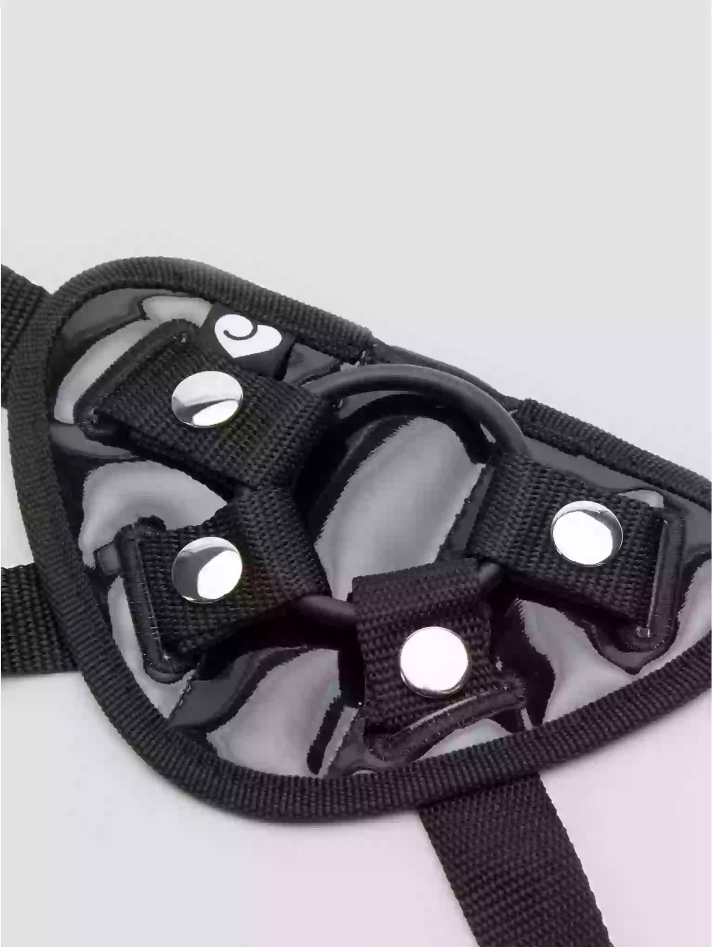 Black dog muzzle with straps on a light gray background
