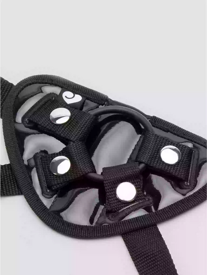 Black dog muzzle with straps on a light gray background