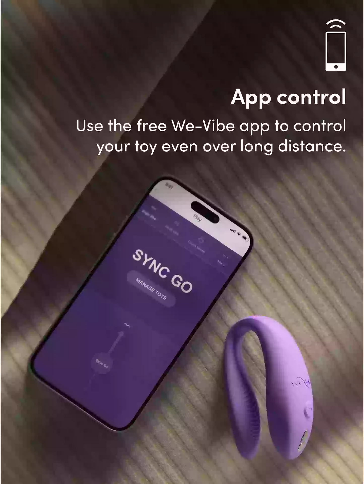 Smartphone with app interface and purple toy on a wooden surface, promoting app control.