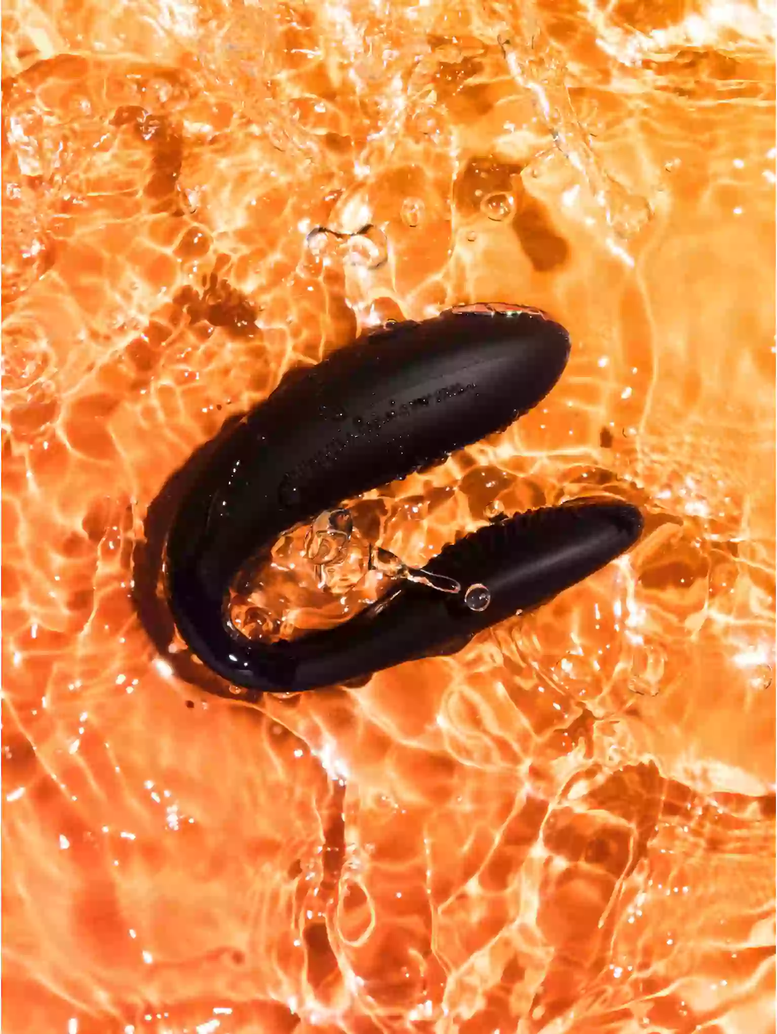 Black object resembling a claw or mechanical component on a fiery orange background