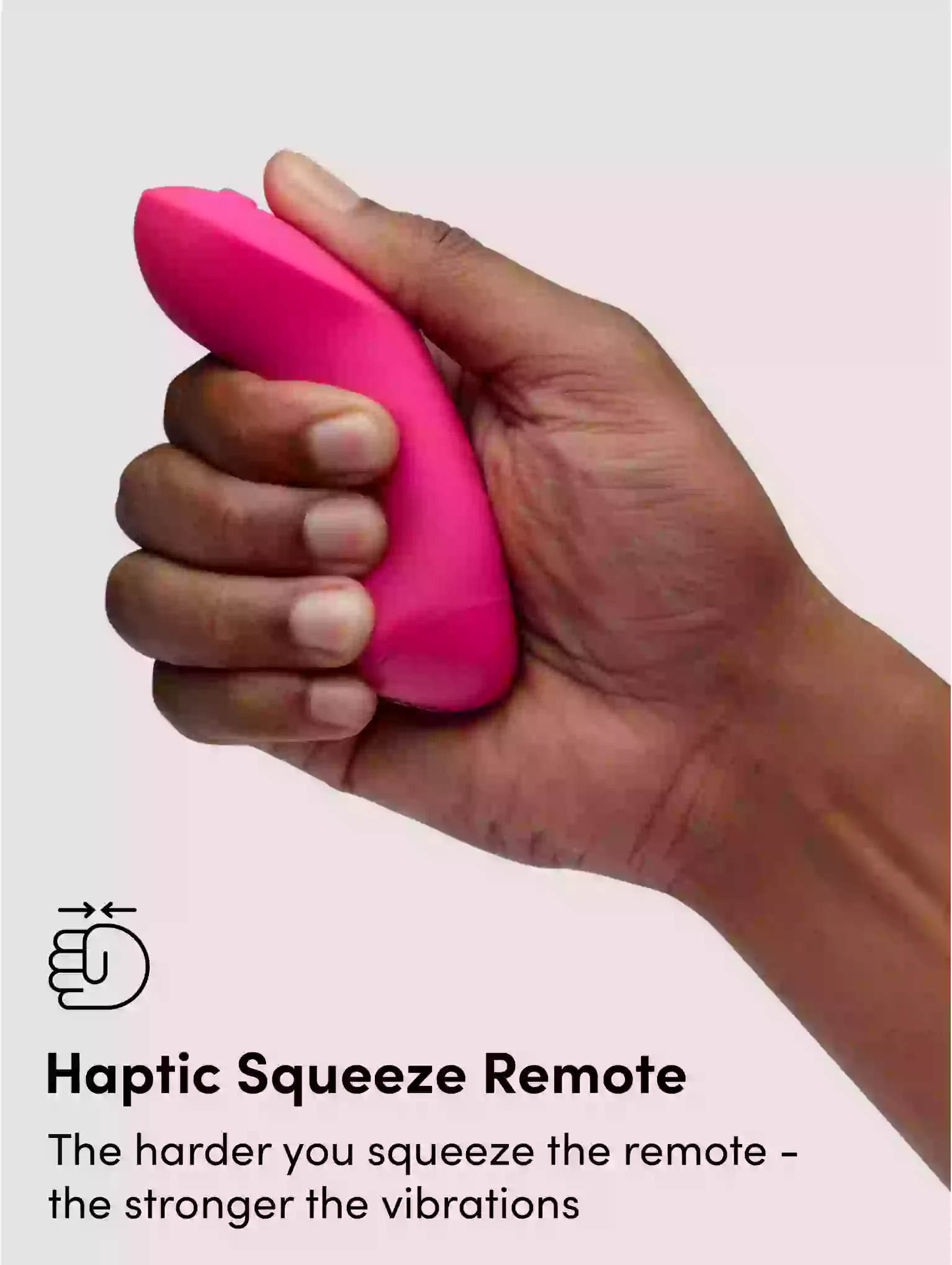Hand holding a pink haptic squeeze remote with text explaining its function.