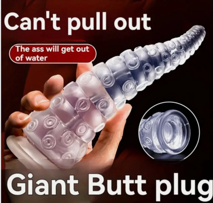 Giant butt plug held by a hand with text indicating it can't be pulled out.