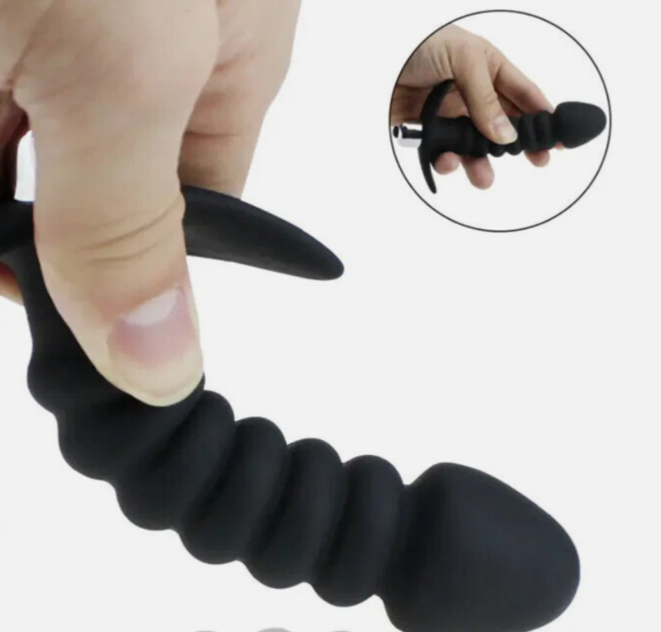 Black textured finger exerciser held by a hand with an inset showing close-up details.