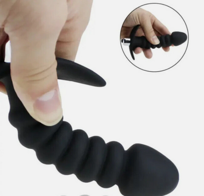 Black textured finger exerciser held by a hand with an inset showing close-up details.