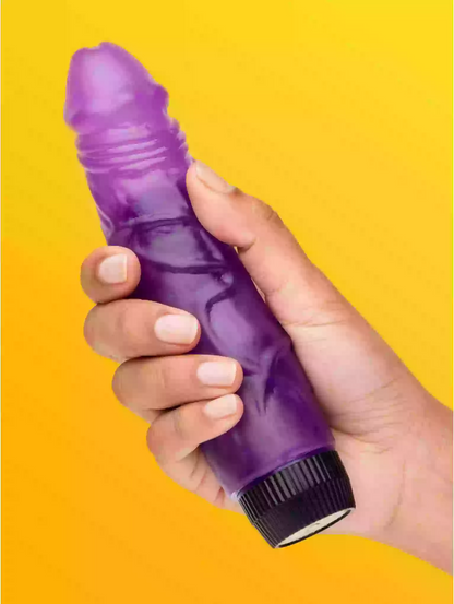 Hand holding a purple and black cylindrical object against a yellow background