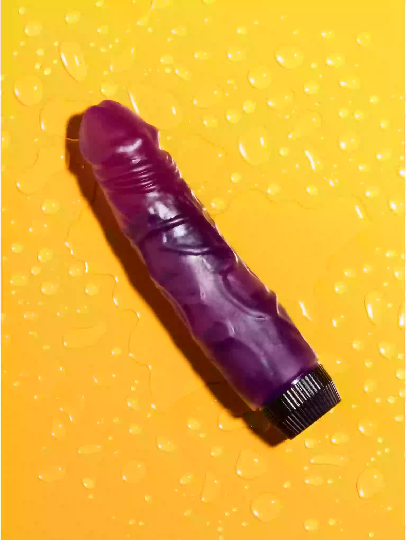 Purple object with textured surface on a yellow textured background