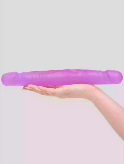 Purple stress ball held in a hand against a light purple background