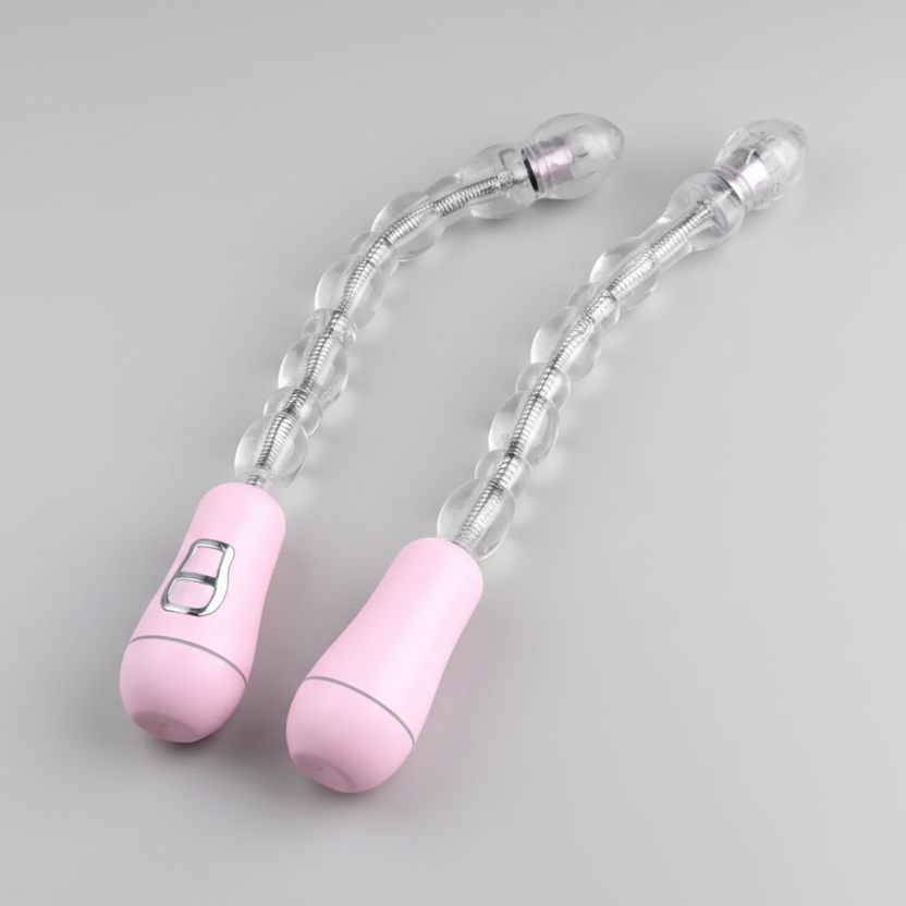 Pink and clear silicone baby rattles on a gray background
