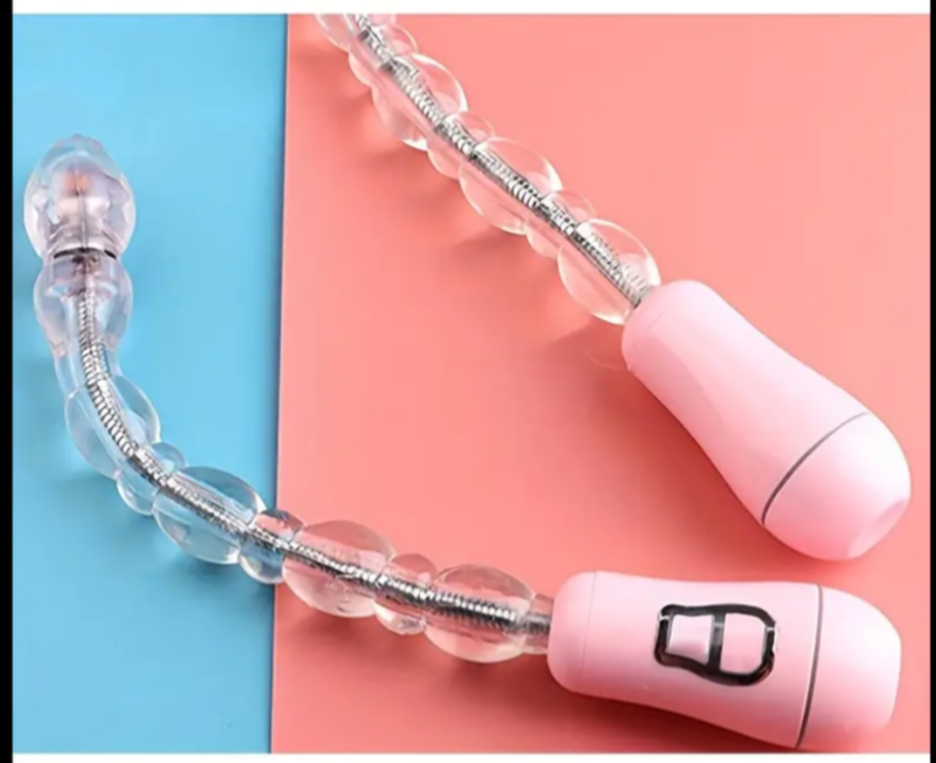 Pink and clear handheld massager on a two-tone blue and pink background
