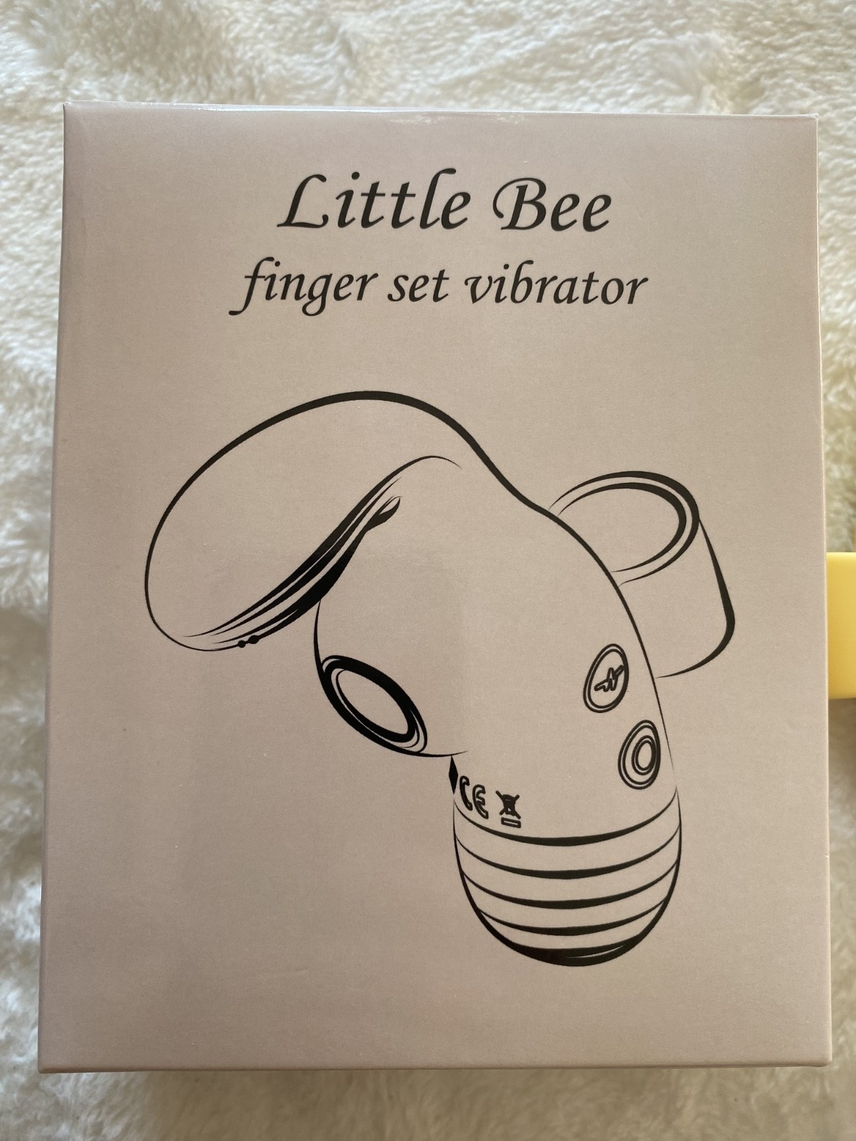 Box of 'Little Bee' finger set vibrator on a textured surface