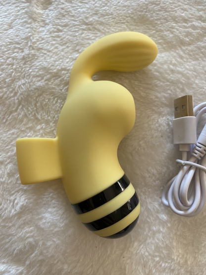 Yellow and black device with a USB cable on a textured surface