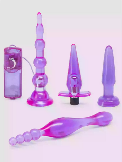 Set of purple and pink silicone butt plugs on a white background