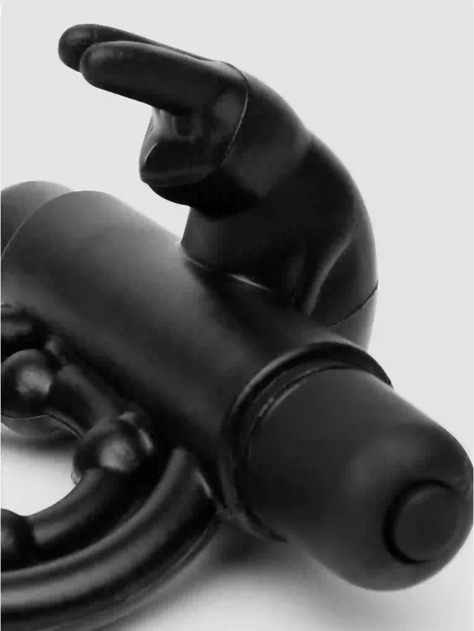 Close-up of a black metal object with a chain on a light gray background