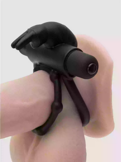 Black plastic tool held by a hand on a light gray background