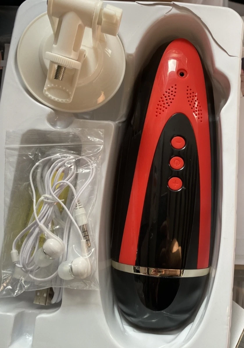 Black and red electronic device with earbuds and charging cable on a white surface