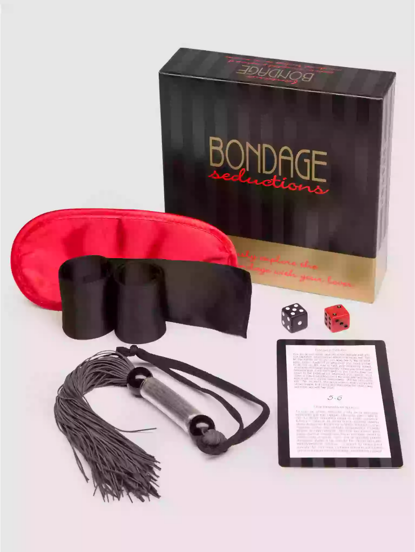 Bondage seductions product set with eye mask, tassels, dice, and card on a white background