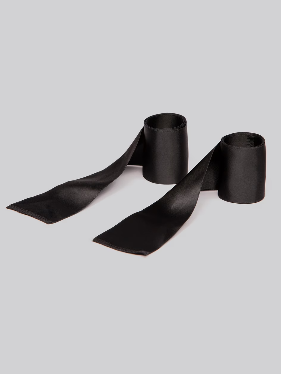 Black satin ribbon on a light gray background