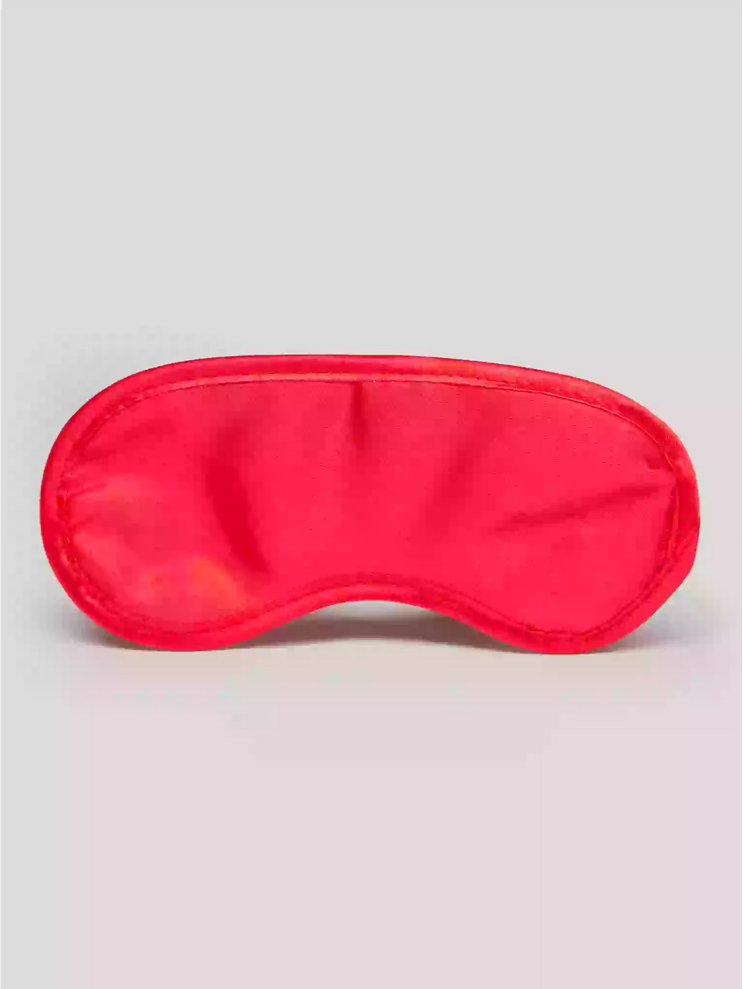 Red sleep mask on a light gray background