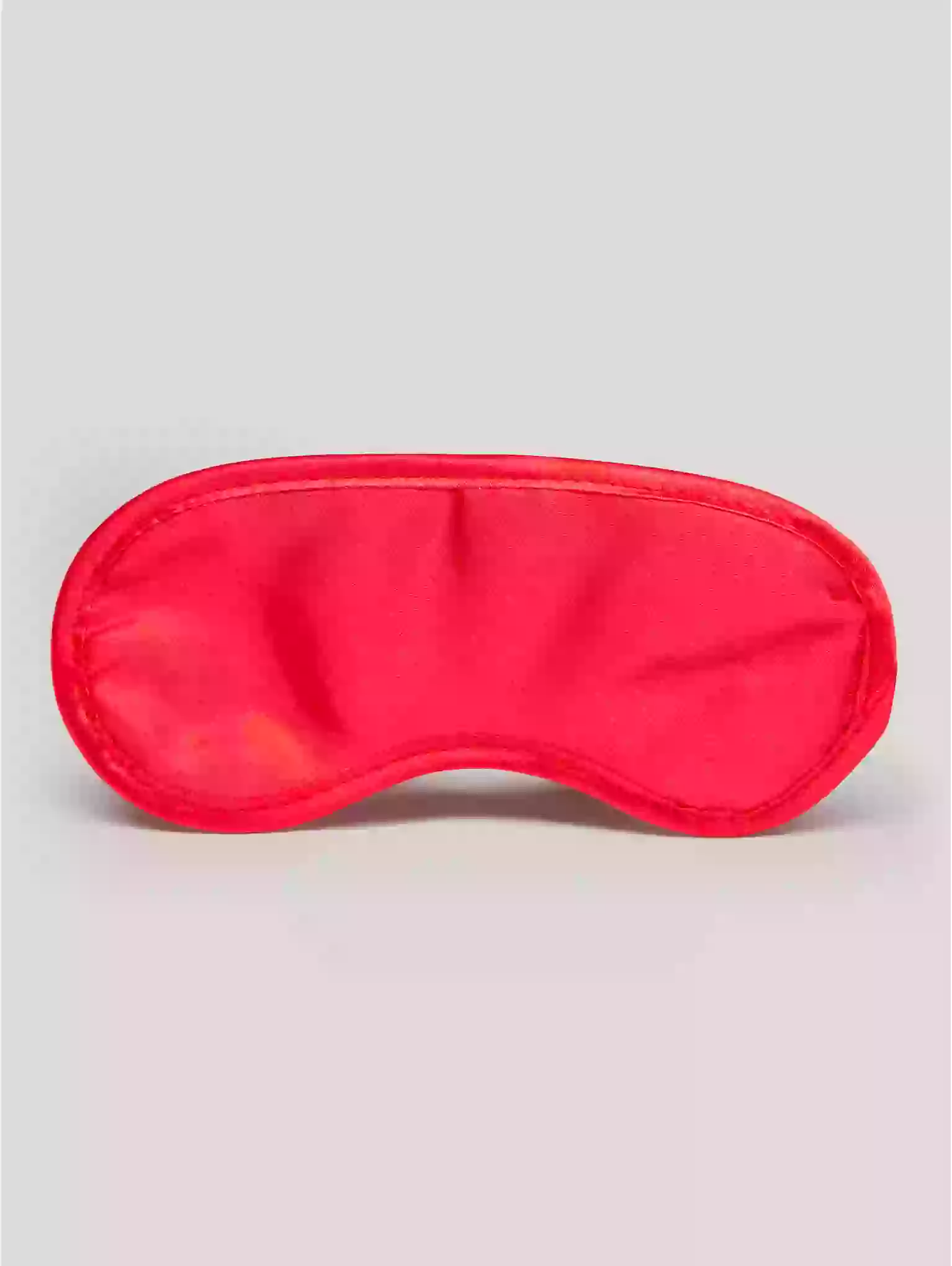 Red sleep mask on a light gray background