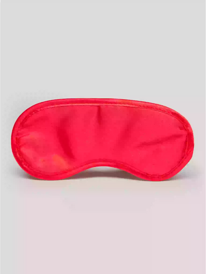 Red sleep mask on a light gray background
