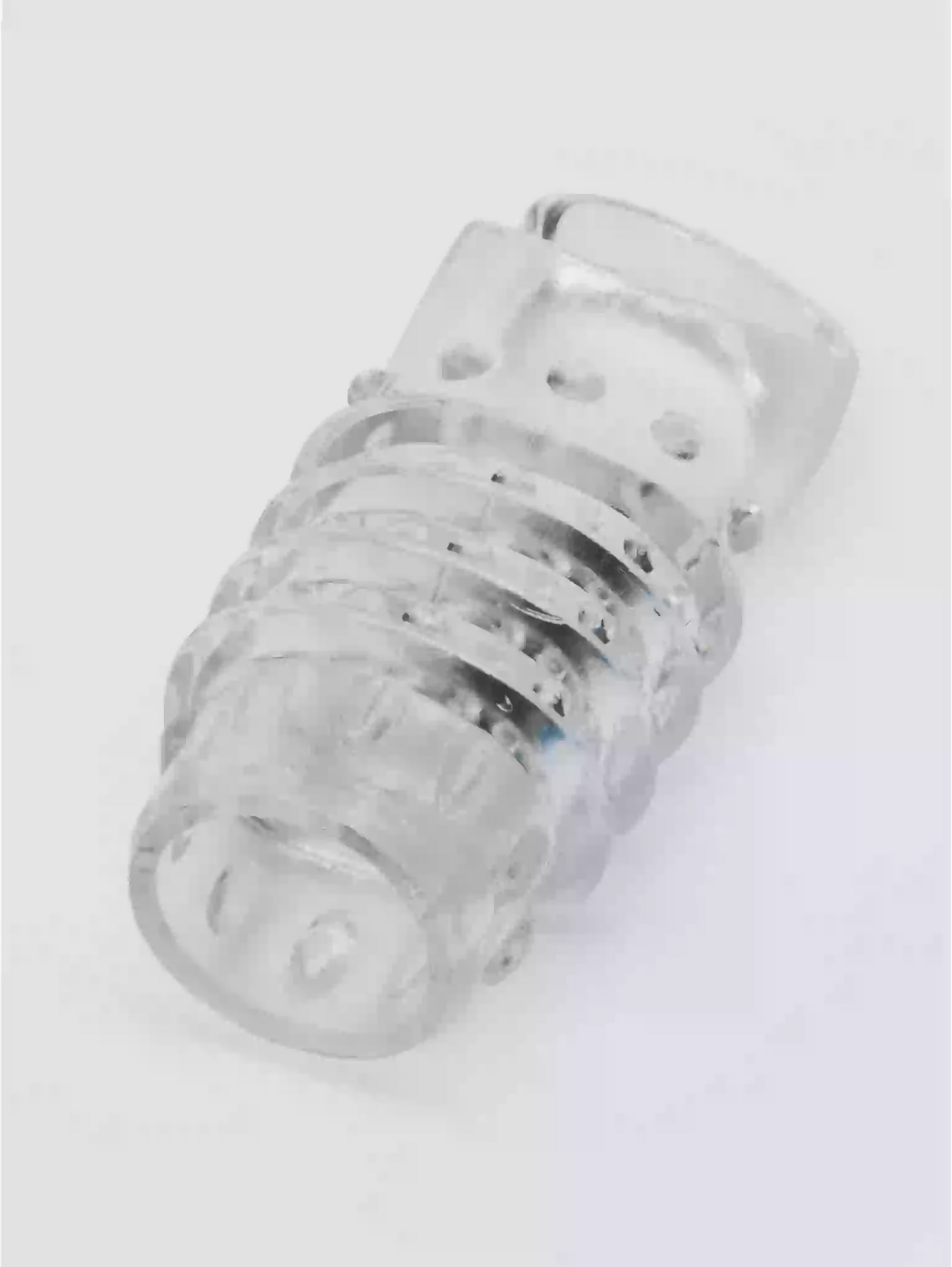 Clear plastic component on a white background