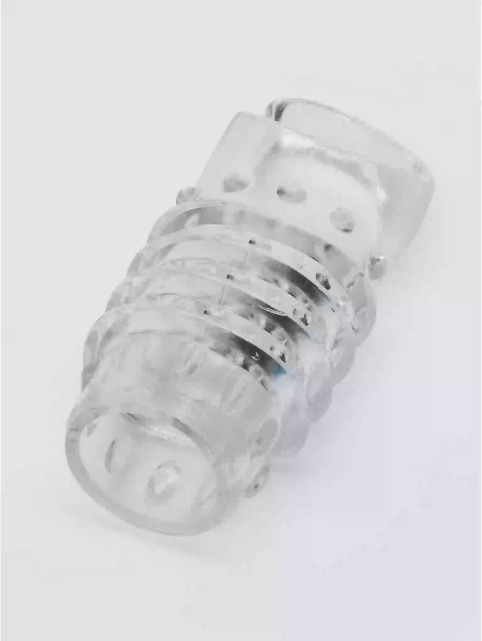 Clear plastic component on a white background