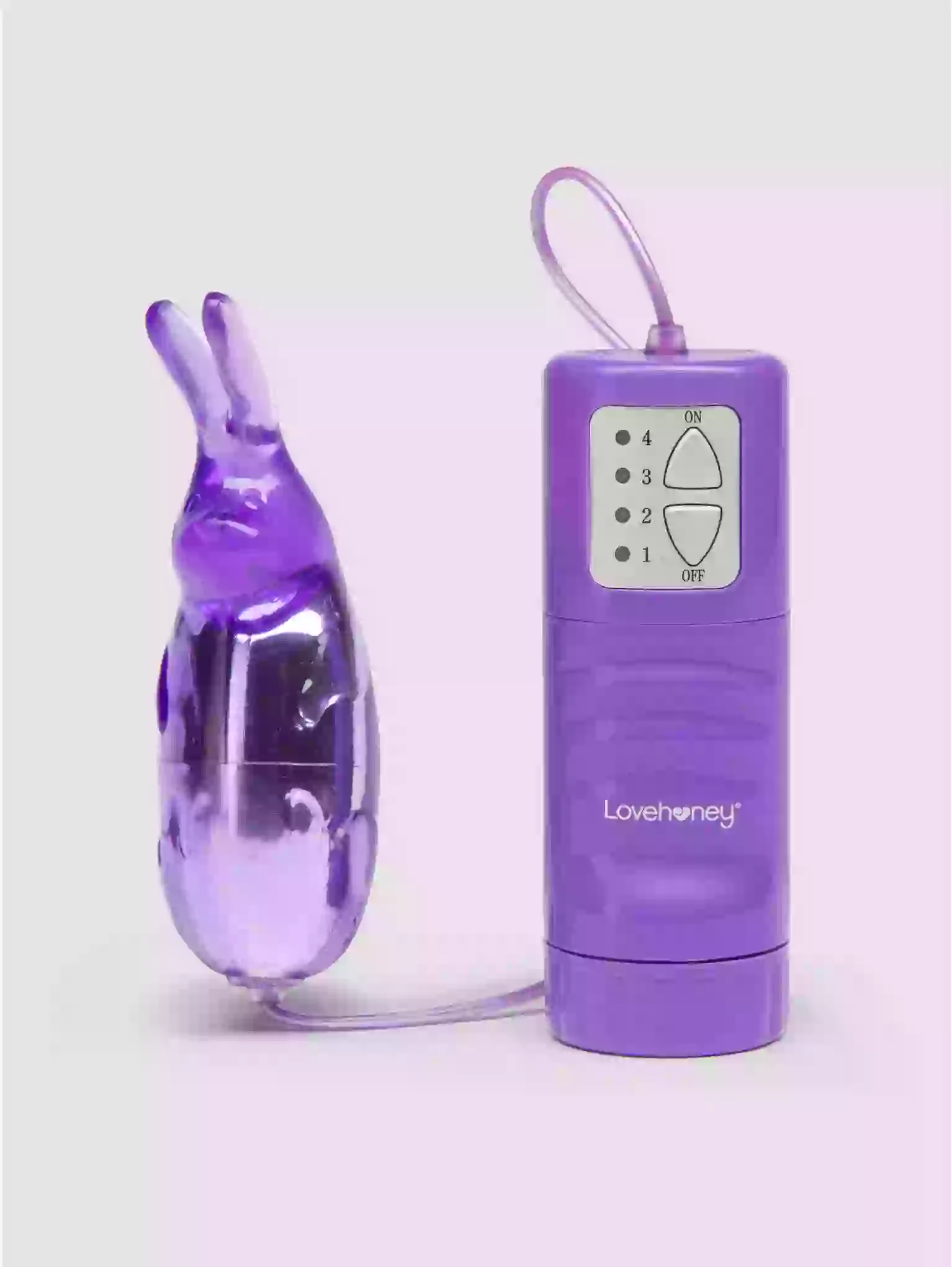 Purple rabbit-shaped toy and remote control with 'Lovehoney' branding on a light purple background