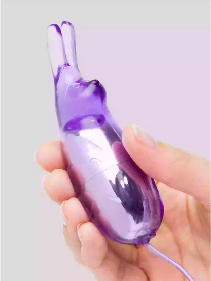 Purple electronic device held in a hand against a light gray background