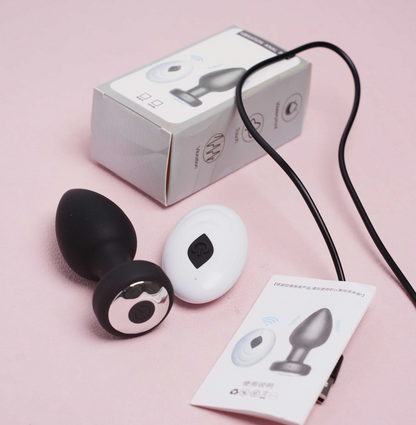 Sexual product with packaging and manual on a pink background