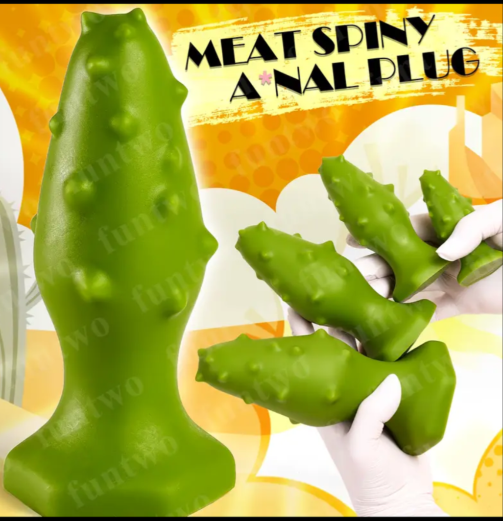 Green spiky object with a hand wearing a white glove holding it, on a yellow and orange background.