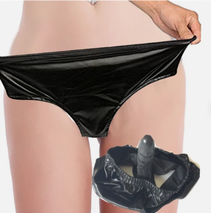 Black underwear held up with a clear plastic bag containing a black object.