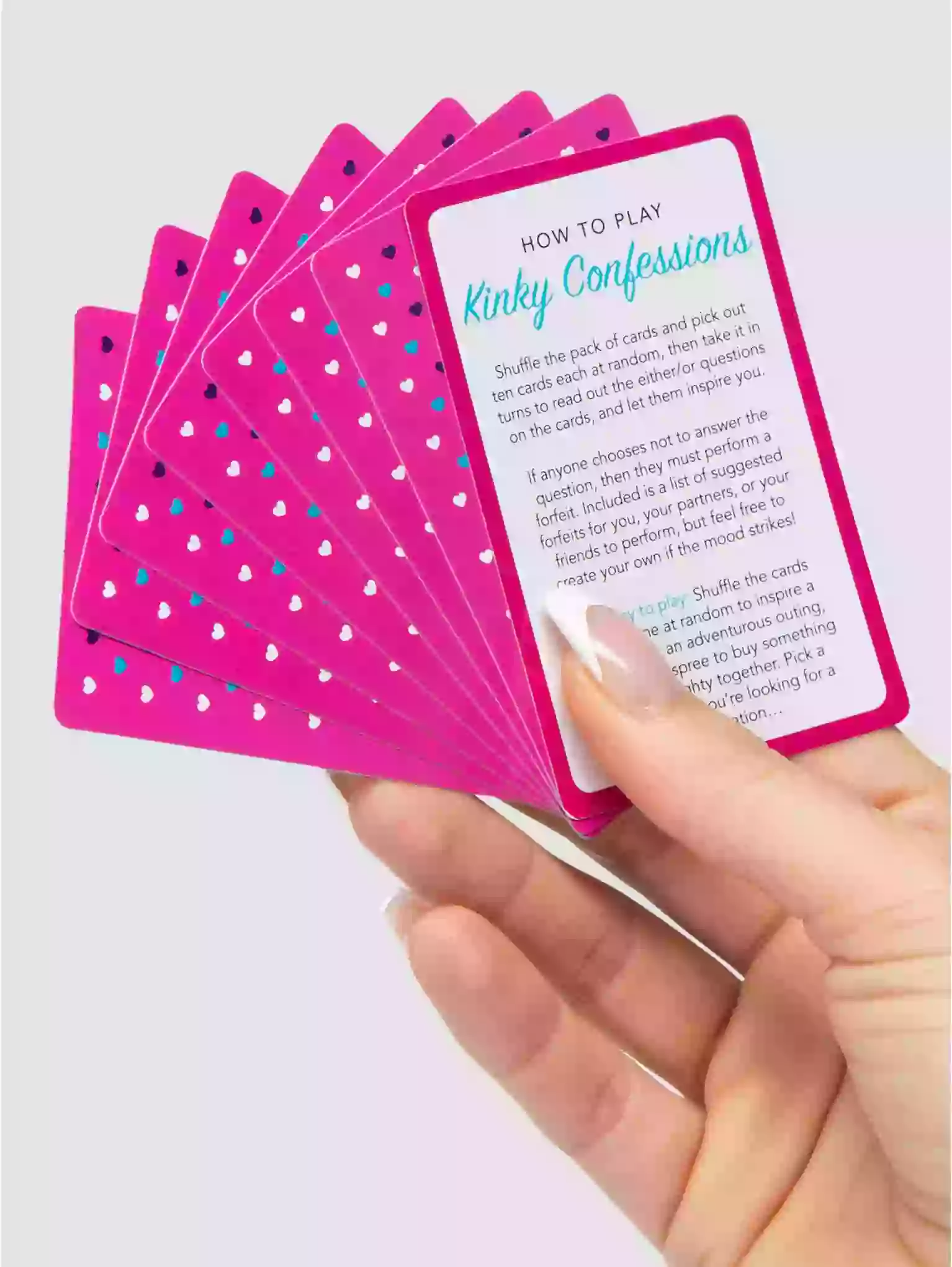 Hand holding a set of pink playing cards with text on a light purple background