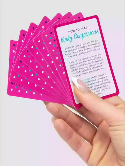 Hand holding a set of pink playing cards with text on a light purple background