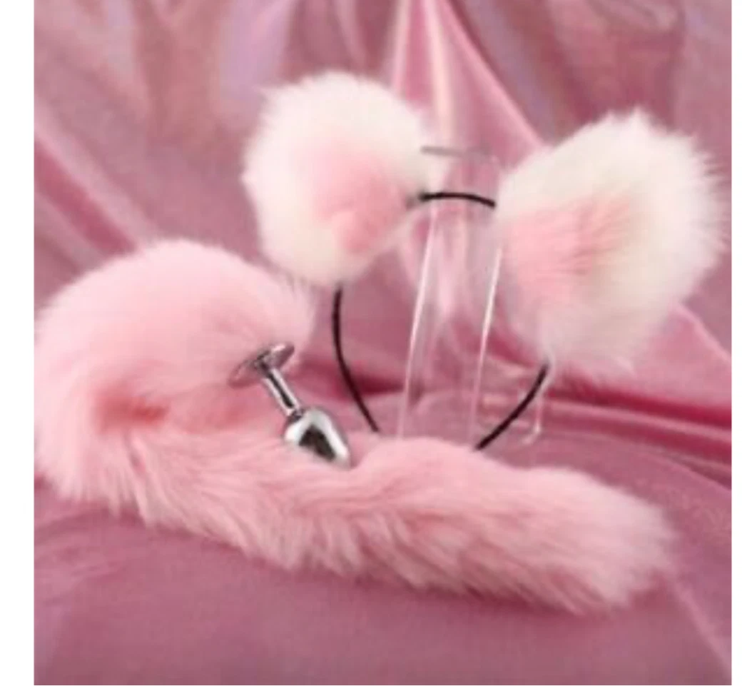 Pink furry handle with a clear grip and silver metal part on a pink background