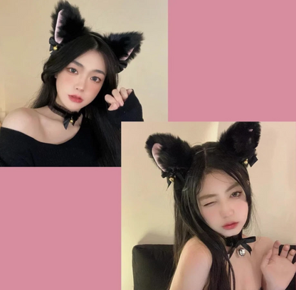 Person wearing black cat ears with pink background
